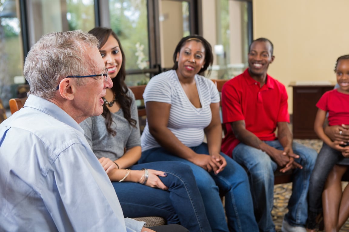 Senior man leading discussion in support group